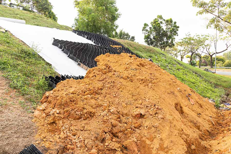 Slope erosion control grid installation