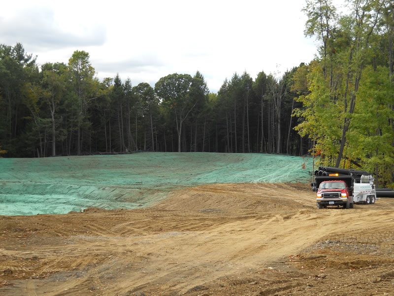 Hydroseeding process showing green mulch application on lawn